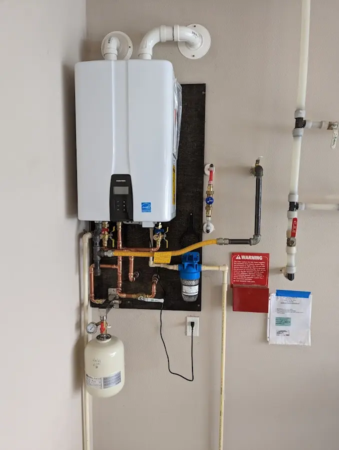 Professional plumber installing copper piping in a Indian Head home